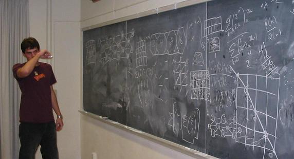 student at board full of equations